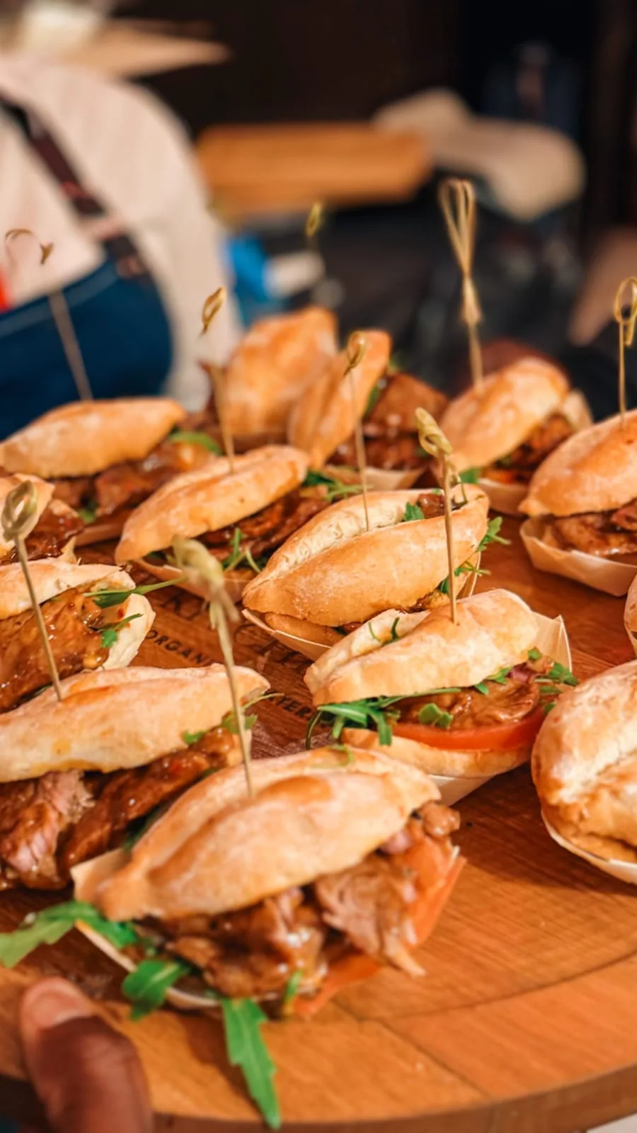 Assorted mini sandwiches served on a wooden platter