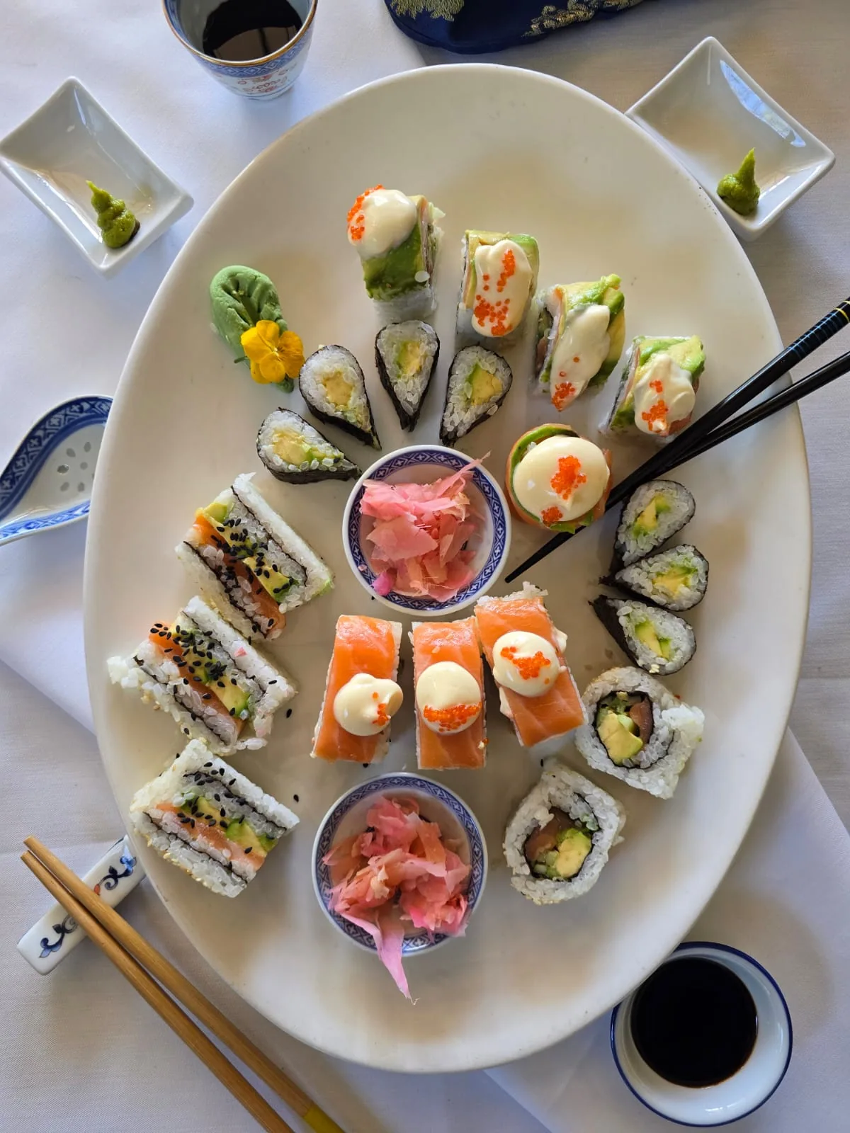 Assorted sushi served on a white platter