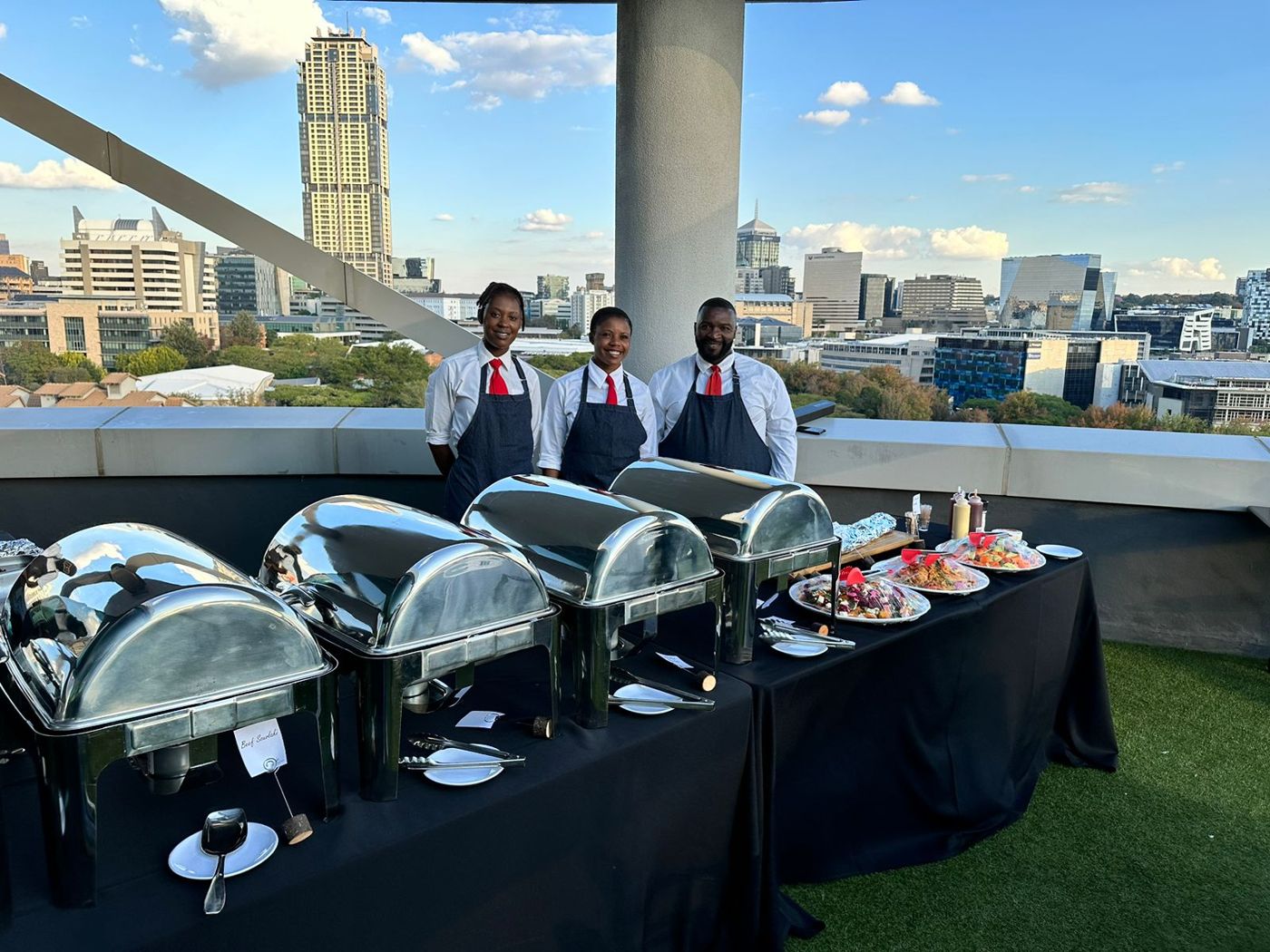 Kitchen Mafia team with chafing dishes at a rooftop buffet in Sandton, buffet catering for events