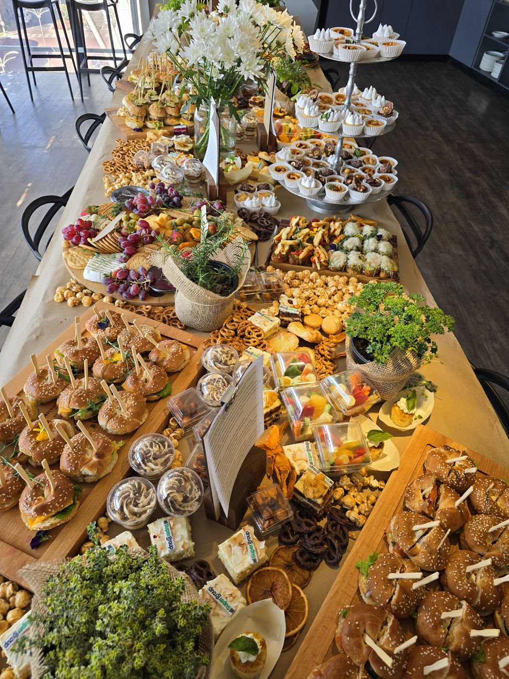 Corporate catering spread with bagels, platters and desserts, corporate catering Sandton