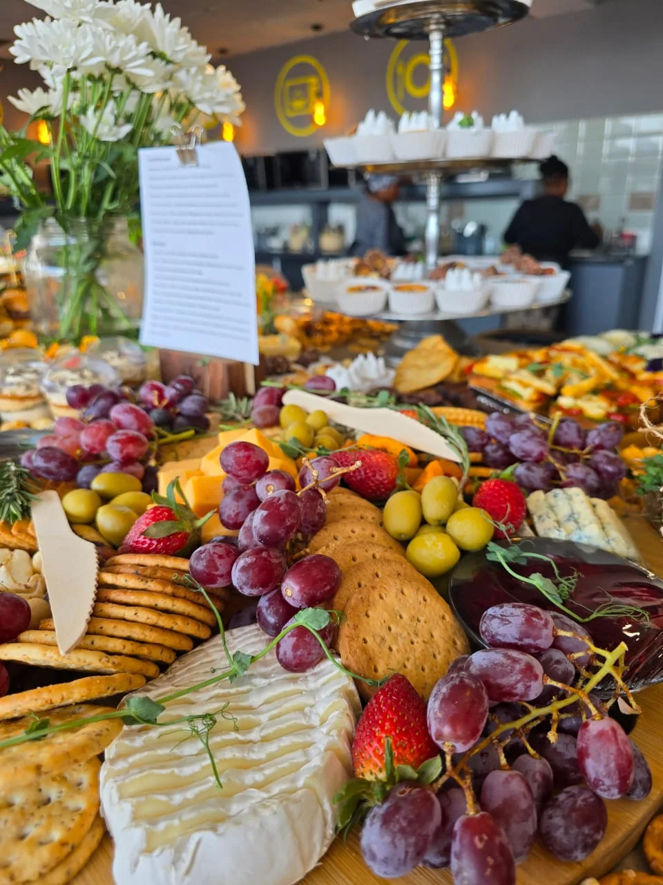 Grazing table with cheeses, breads and fresh fruit at an event