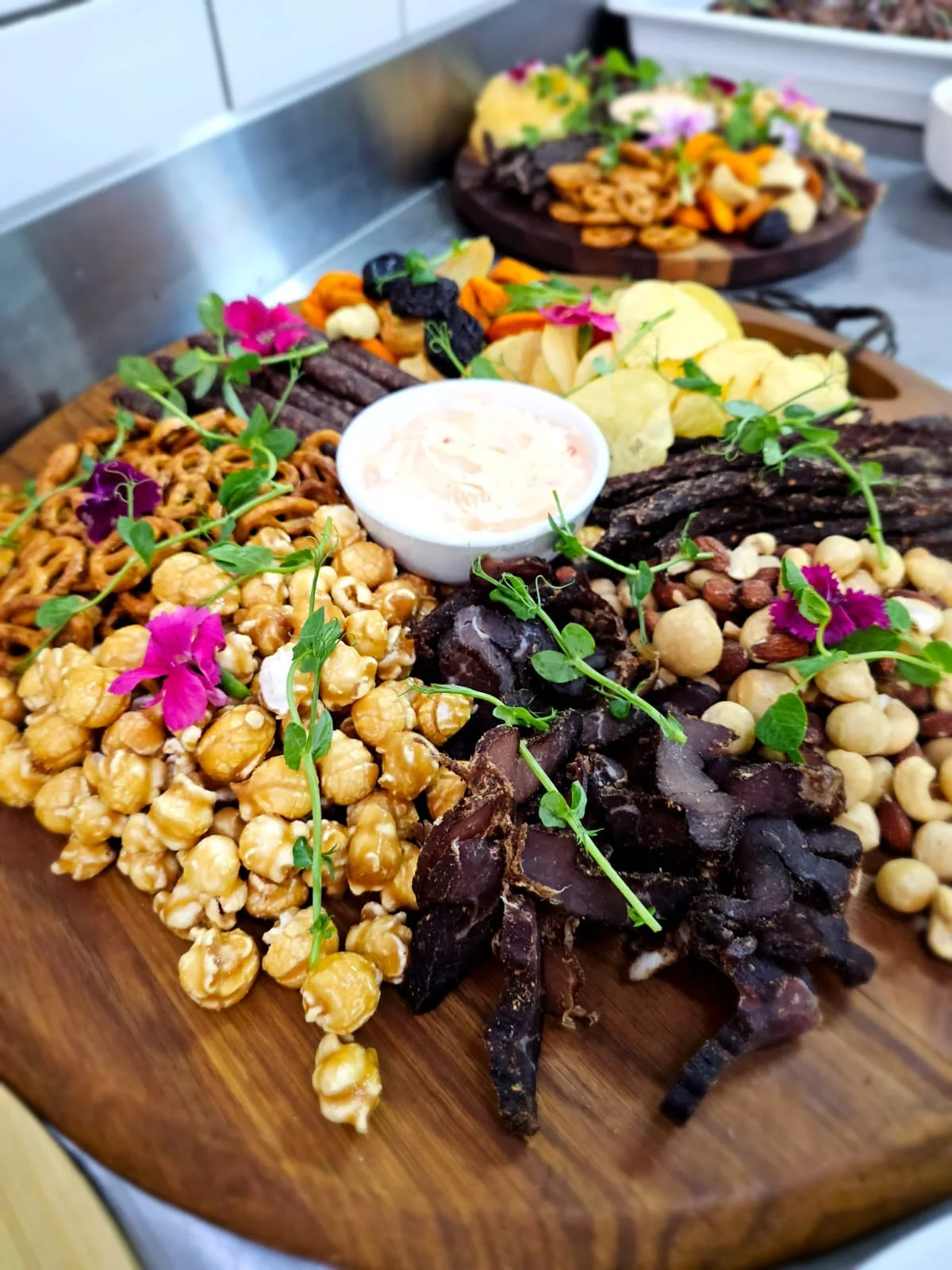Grazing board with fruit, cheeses and savoury bites