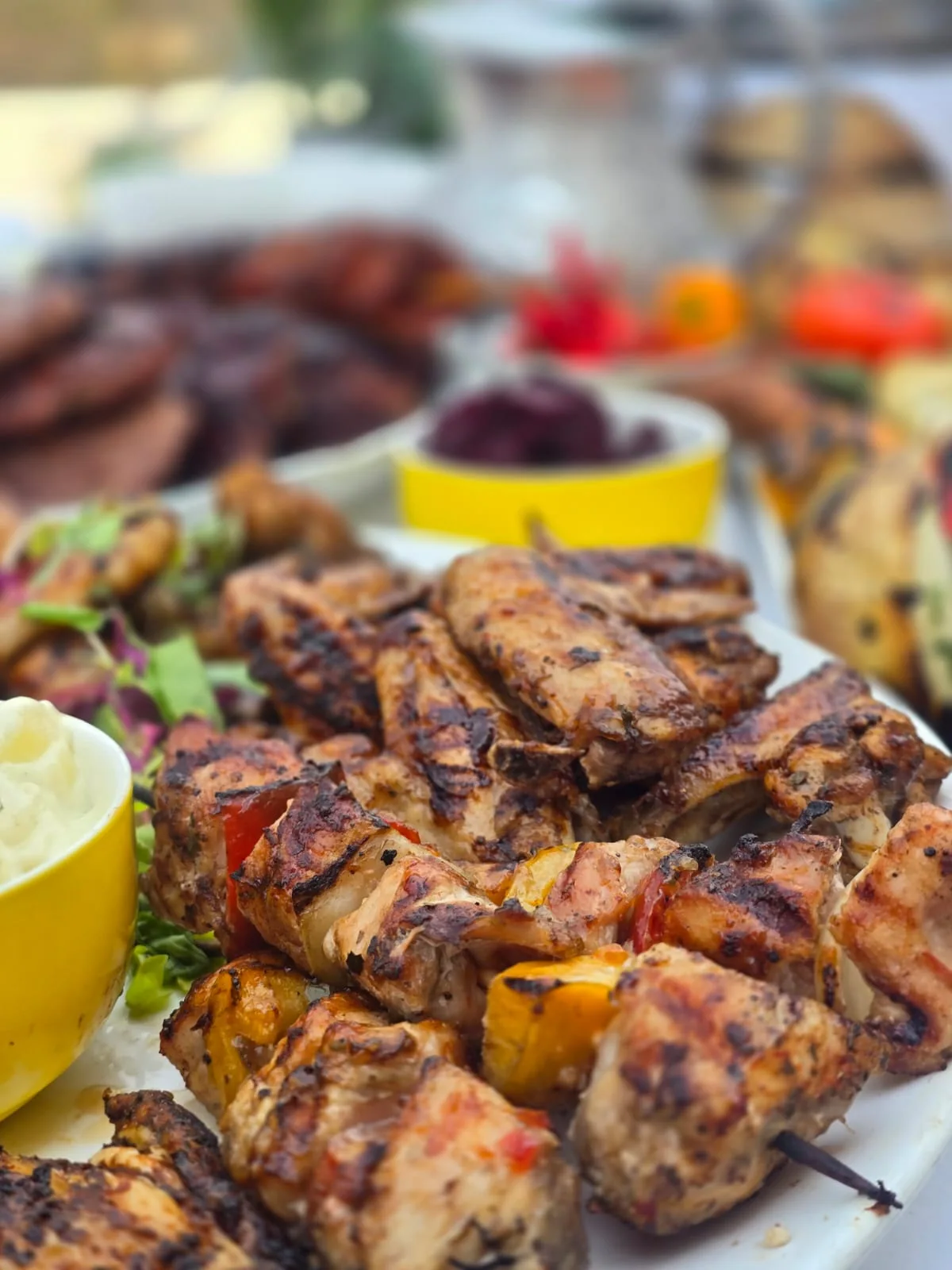 Grilled meat platter with colourful braai side dishes
