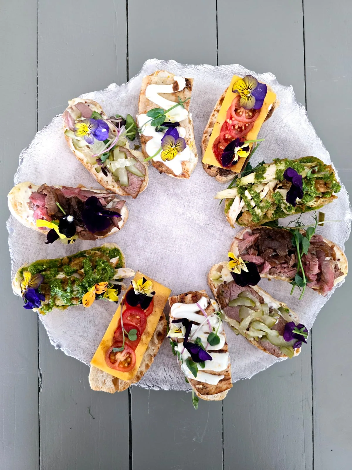 Assorted mini wraps and canapés arranged in a circle