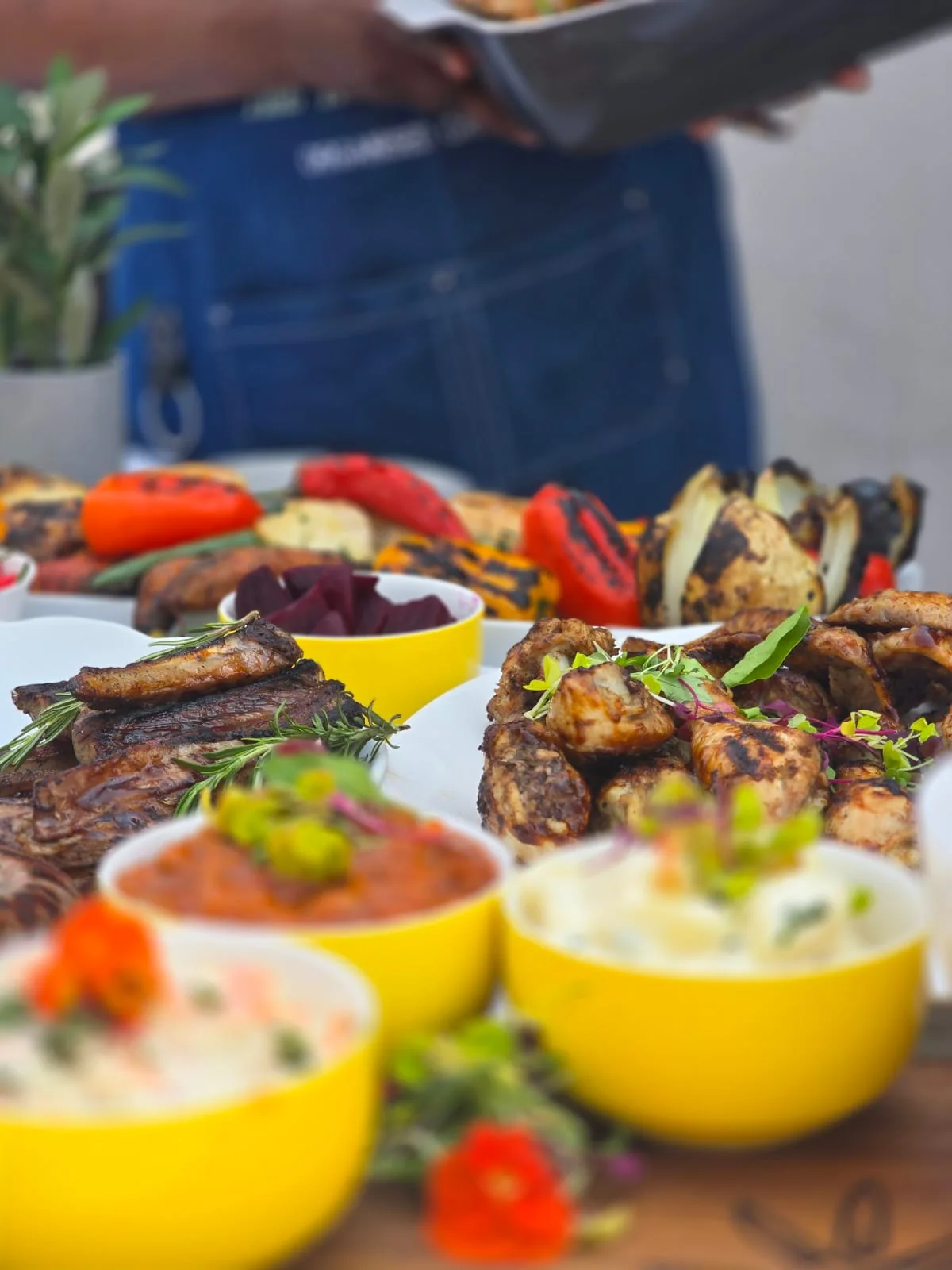 Outdoor braai catering with grilled meats and side dishes