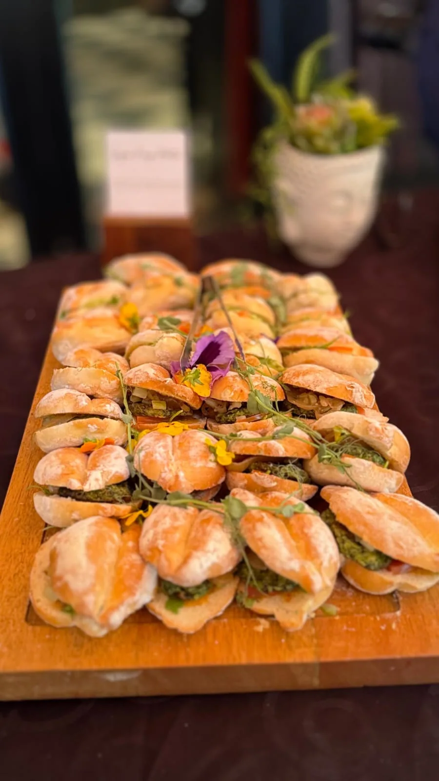 Smoked salmon canapés arranged on a wooden serving board