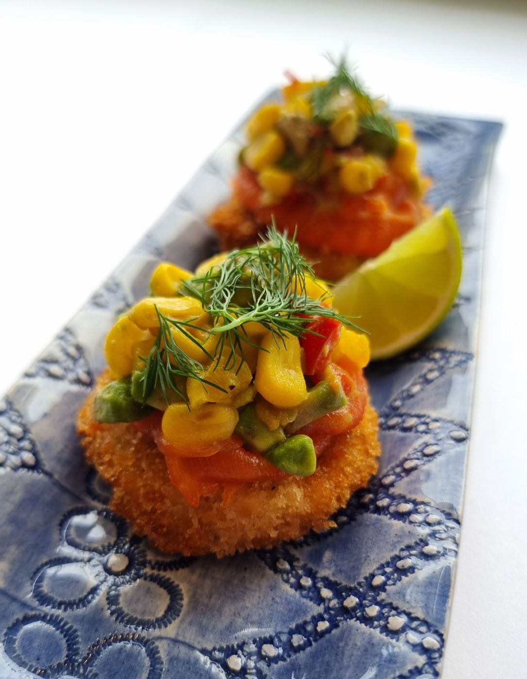 Salmon cakes with corn and avocado salsa, tapas and bowl food catering